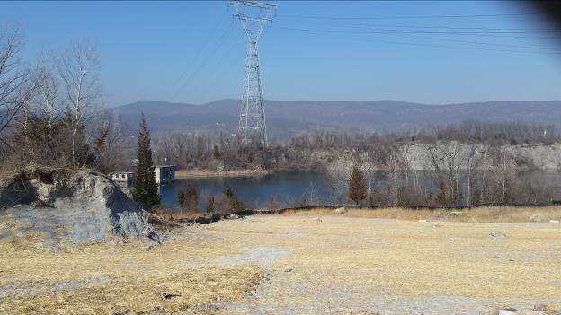 Rock cliffs surrounding quarry pond